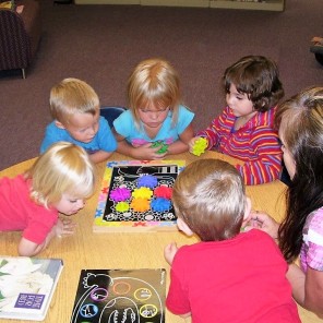 Children enjoy puzzles and games in the Children's section of the library.